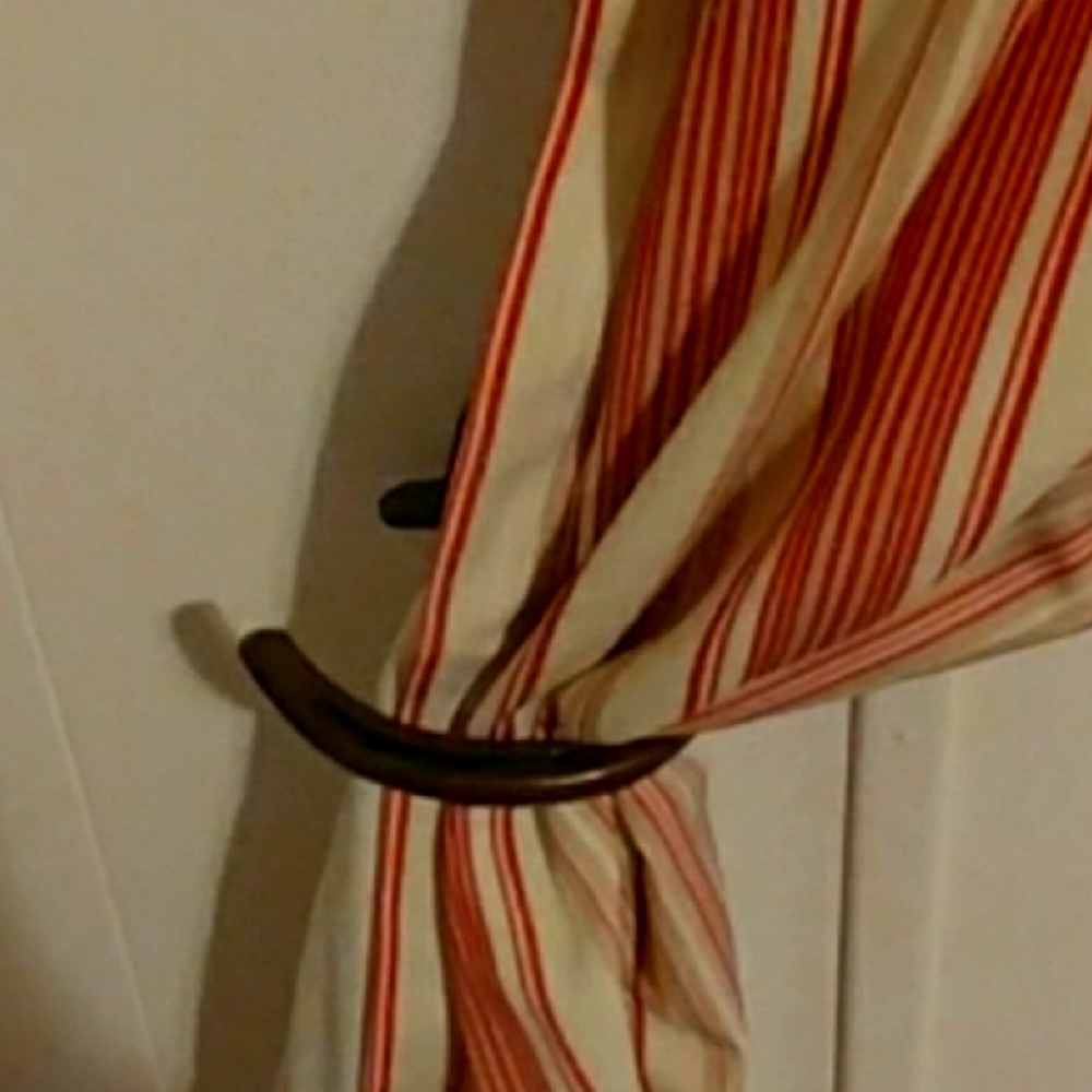 Western curtain rod holders and tie backs
